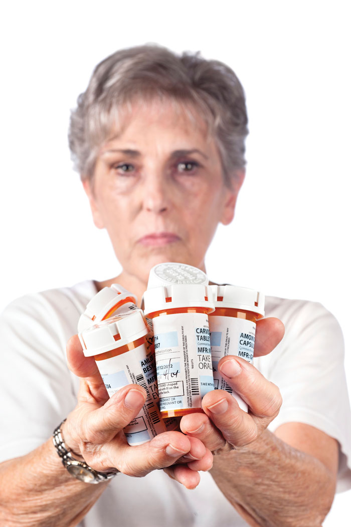 Woman holding several prescription vials