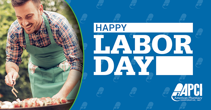 A man cooks on a barbecue grill with a Happy Labor Day message from APCI