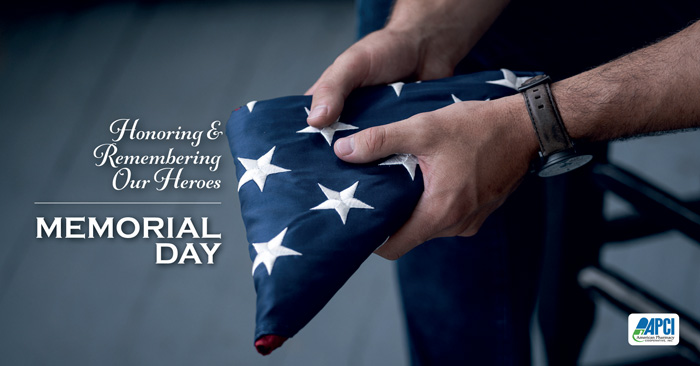 Image of hands holding a folded U.S. flag with Memorial Day text