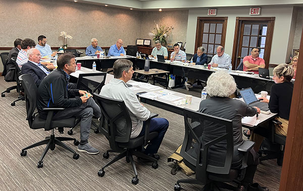 APCI board members and staff seated around a table at the APCI office in Frankfort, KY