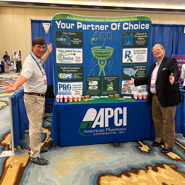 APCI's Mike Johnson and Bill Eley show off the APCI exhibit booth